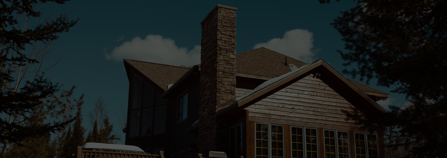 Cabin in woods with brick chimney